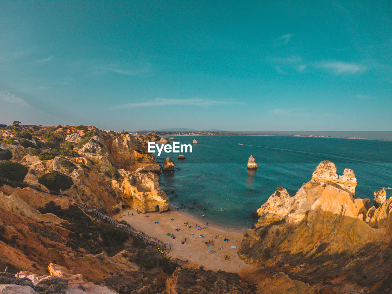 Panoramic view of rocks on sea shore against sky