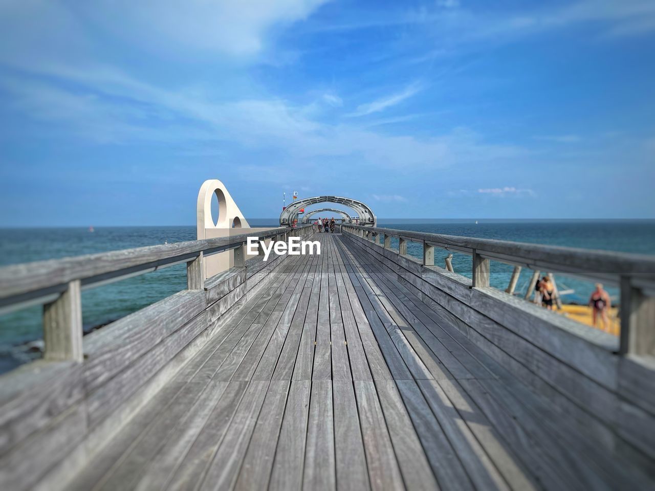 PIER ON BEACH AGAINST SKY