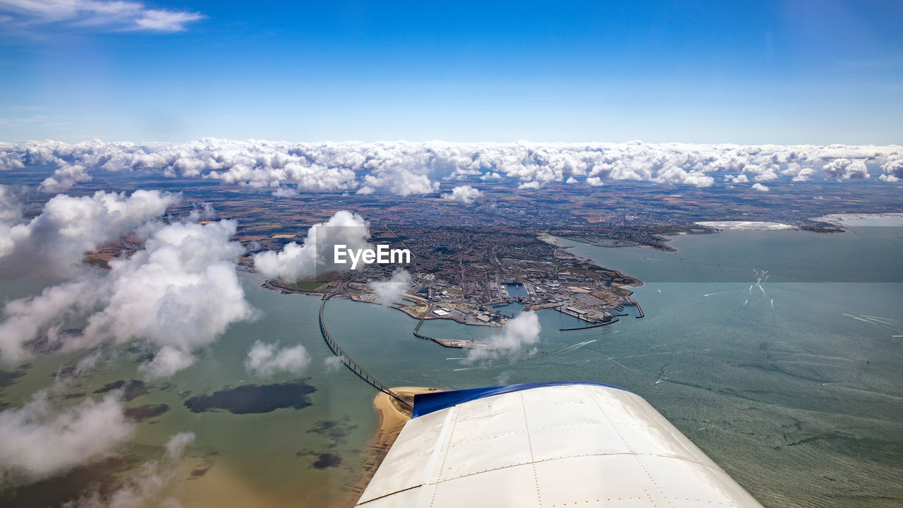 Aerial view of sea and mountains against sky