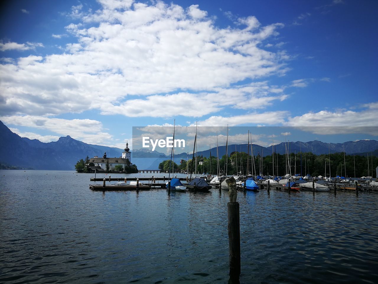 SAILBOATS MOORED IN BAY