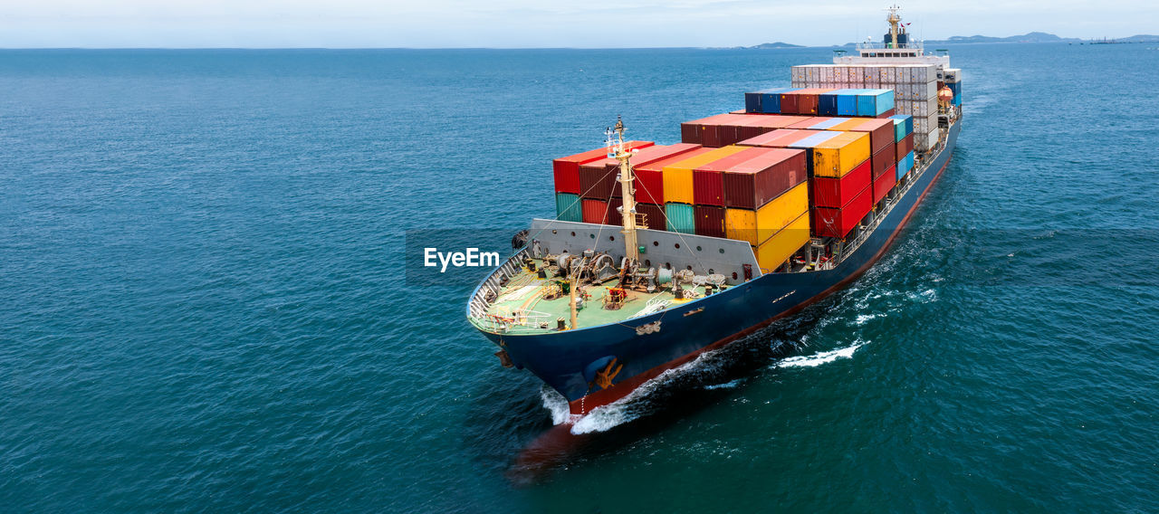 HIGH ANGLE VIEW OF SHIP ON SEA AGAINST SKY