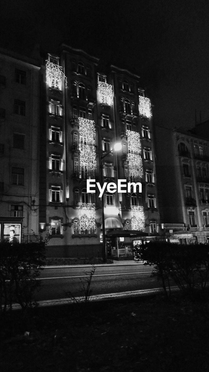 VIEW OF ILLUMINATED BUILDINGS AT NIGHT