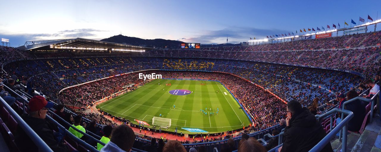 HIGH ANGLE VIEW OF SOCCER FIELD AGAINST SKY