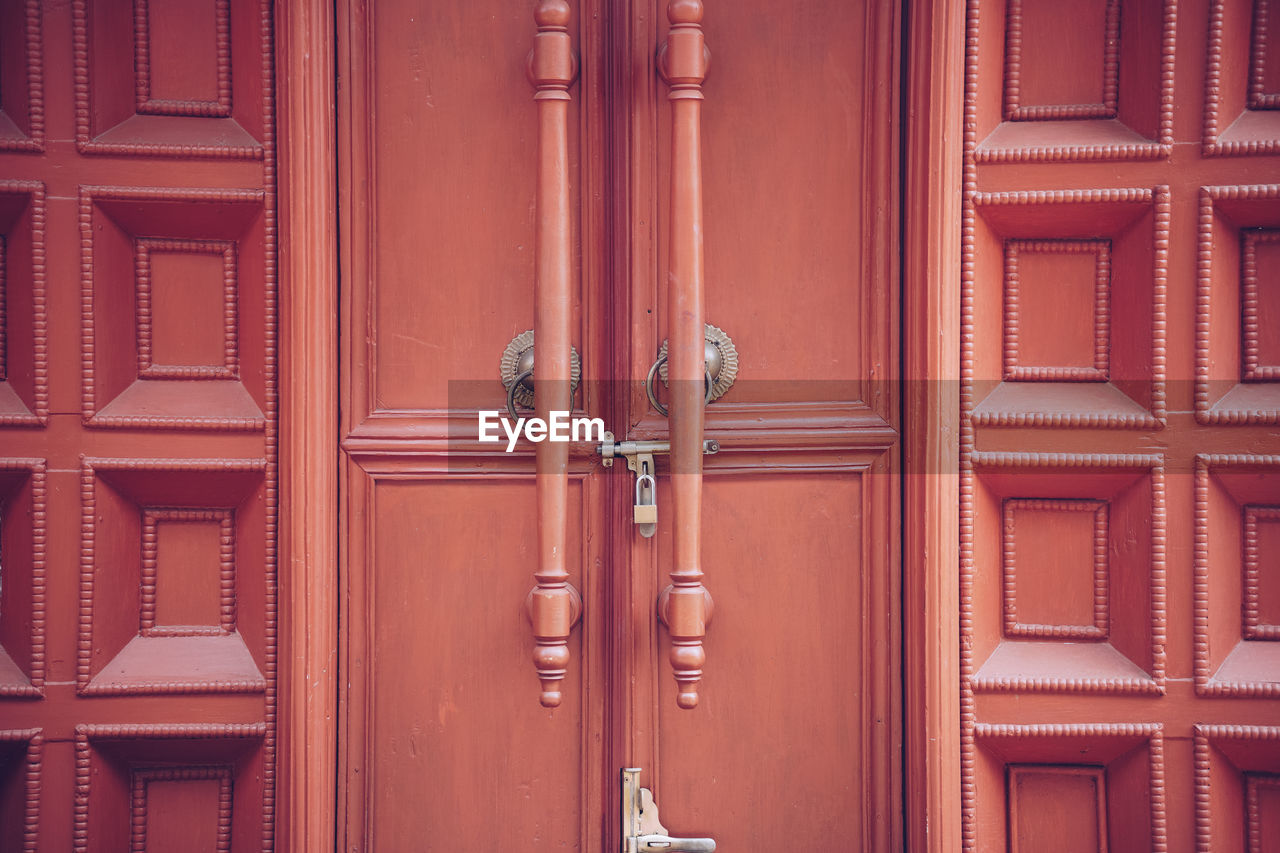 FULL FRAME SHOT OF CLOSED DOOR WITH BUILDING