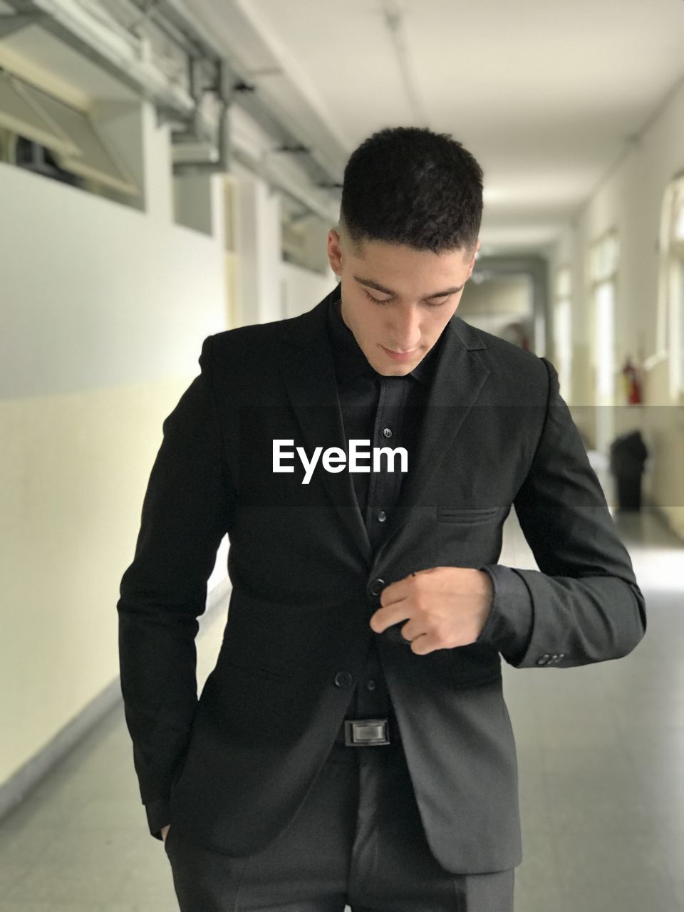 one person, men, adult, business, standing, businessman, indoors, formal wear, clothing, tuxedo, young adult, corporate business, architecture, front view, looking, business finance and industry, blazer, three quarter length, fashion, occupation, white-collar worker, office, serious, focus on foreground