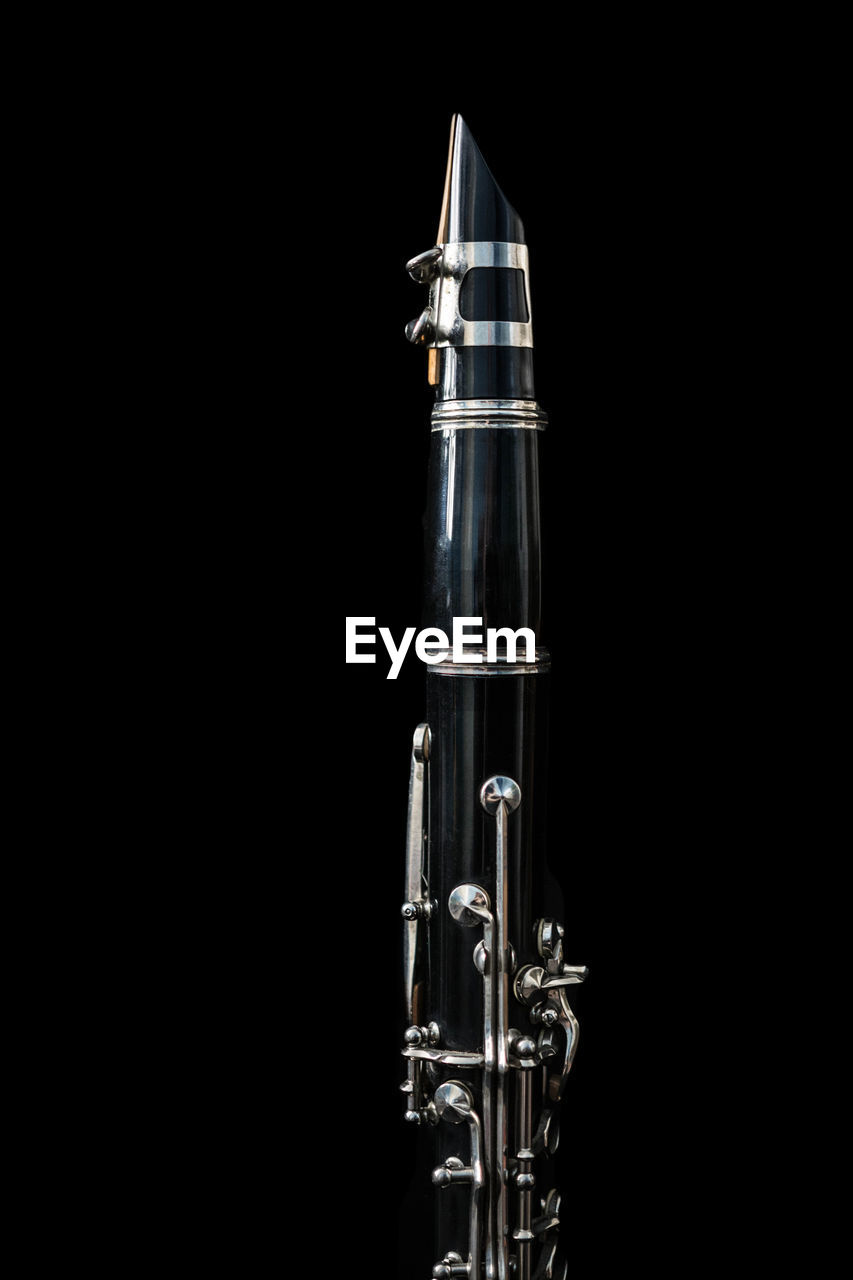 Close-up of flute against black background