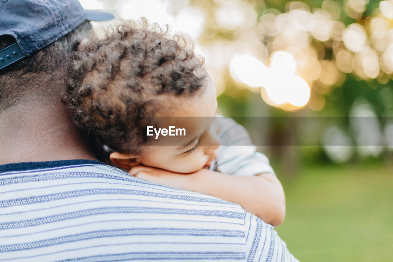 Diverse mixed race toddler boy and african american or black father bonding together as family