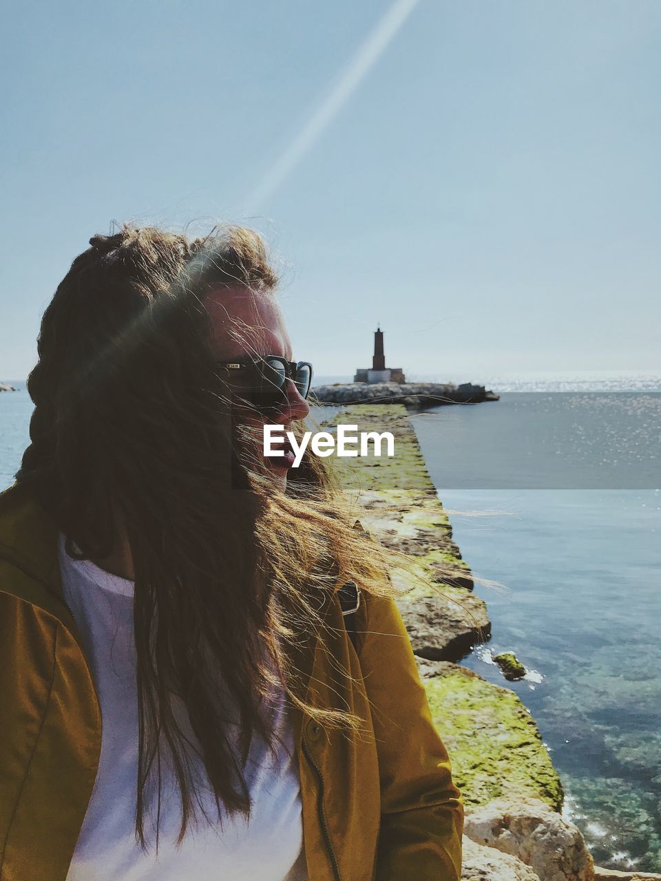 Woman looking at sea against sky