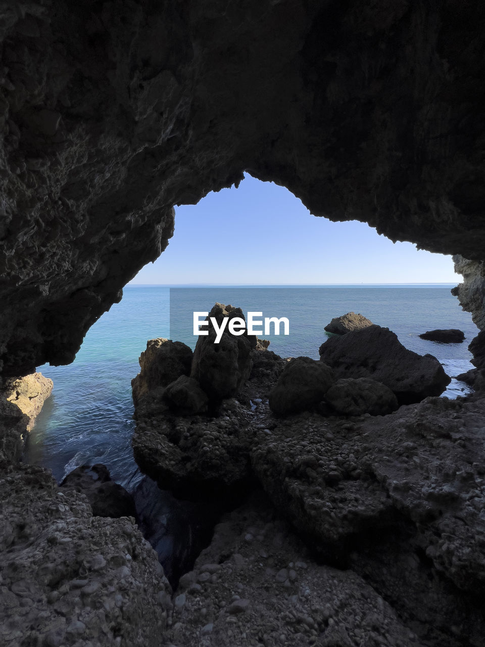 rock, water, sea, rock formation, sky, cave, nature, land, natural arch, beach, coast, beauty in nature, scenics - nature, formation, sea cave, arch, tranquility, no people, geology, ocean, outdoors, travel destinations, horizon over water, clear sky, hole, non-urban scene, blue, day, environment, physical geography, travel, architecture, darkness, tranquil scene, silhouette, terrain, bay, dark, horizon, landscape, idyllic, cliff