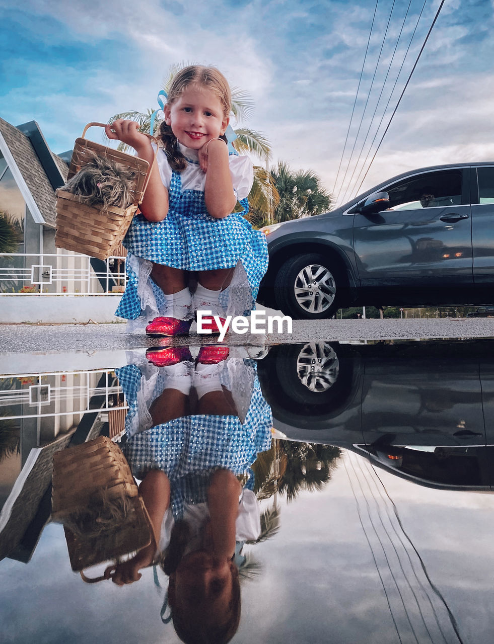 FULL LENGTH OF WOMAN STANDING BY CAR ON ROAD