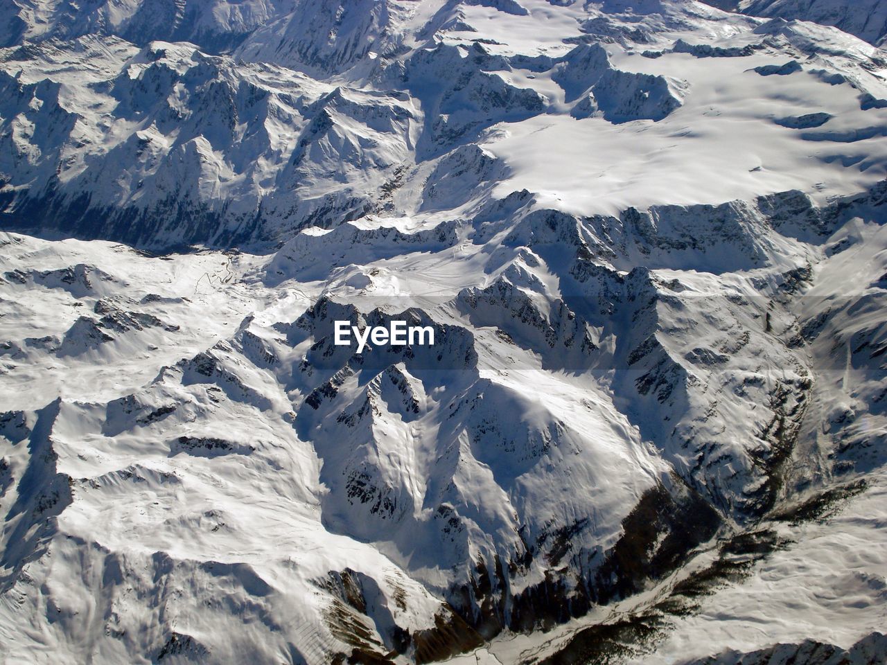 AERIAL VIEW OF SNOWCAPPED MOUNTAIN