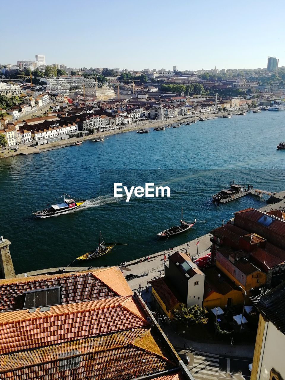 High angle view of river amidst buildings in city against sky