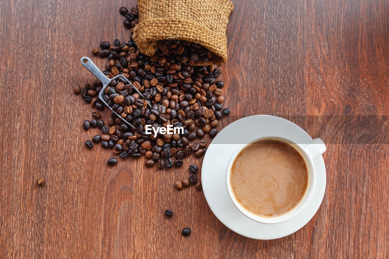 HIGH ANGLE VIEW OF COFFEE CUP WITH COOKIES ON TABLE