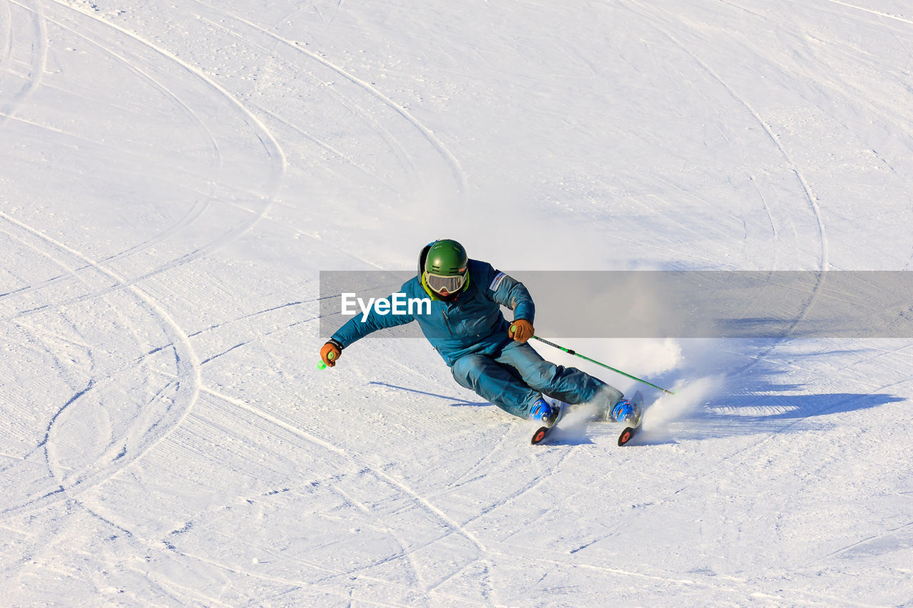 HIGH ANGLE VIEW OF MAN SKIING ON SNOW