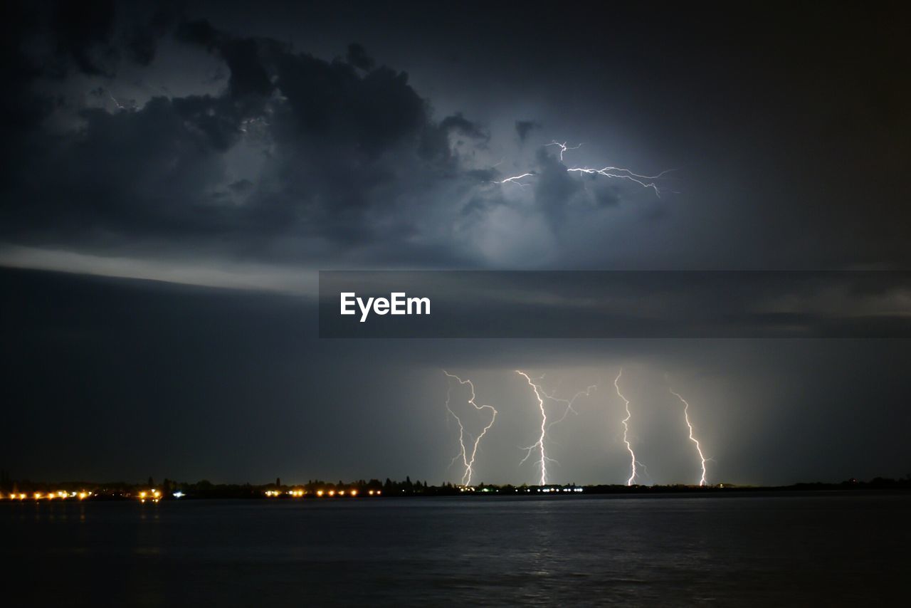 Lightning over lake at night