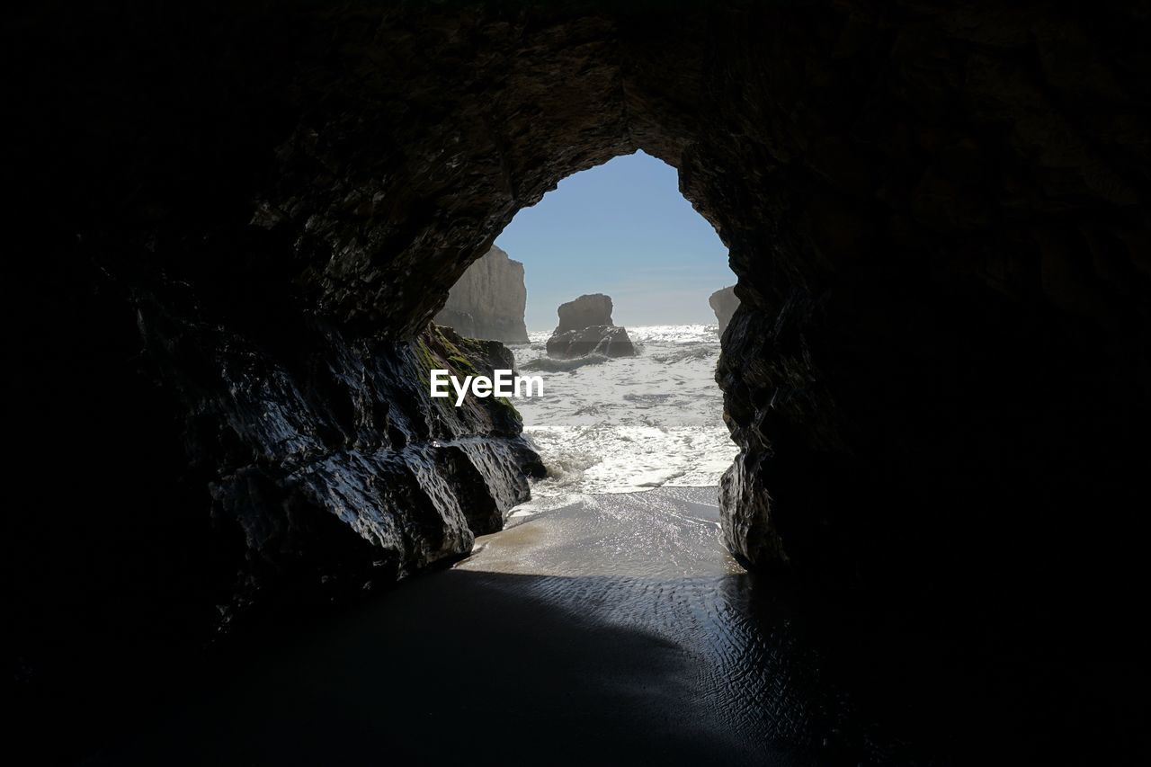 Sea against sky seen from cave