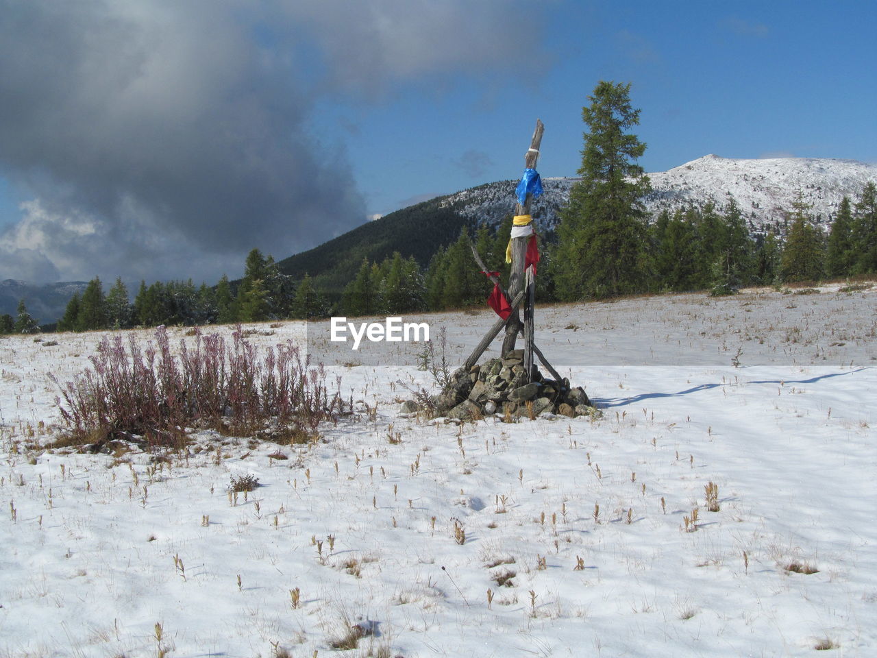 MAN STANDING ON SNOWCAPPED MOUNTAINS AGAINST SKY