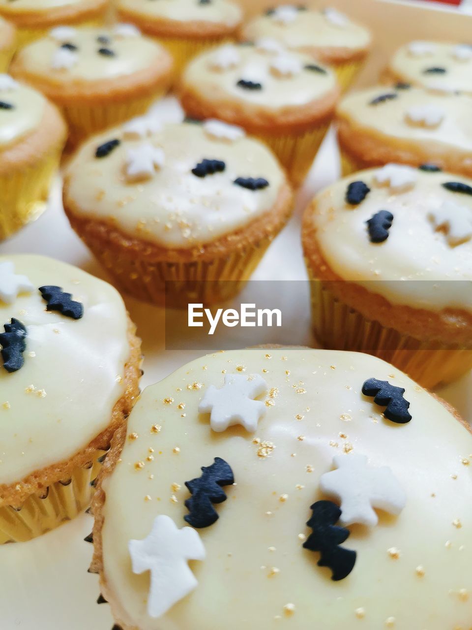 Close-up of iced cupcakes on table with halloween festive holiday sugar decorations
