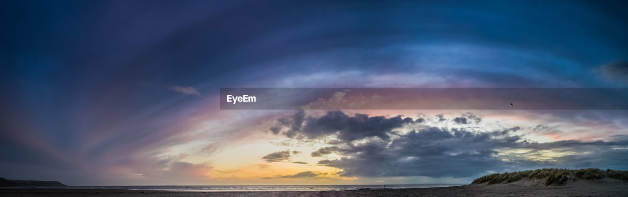 Scenic view of sea against dramatic sky