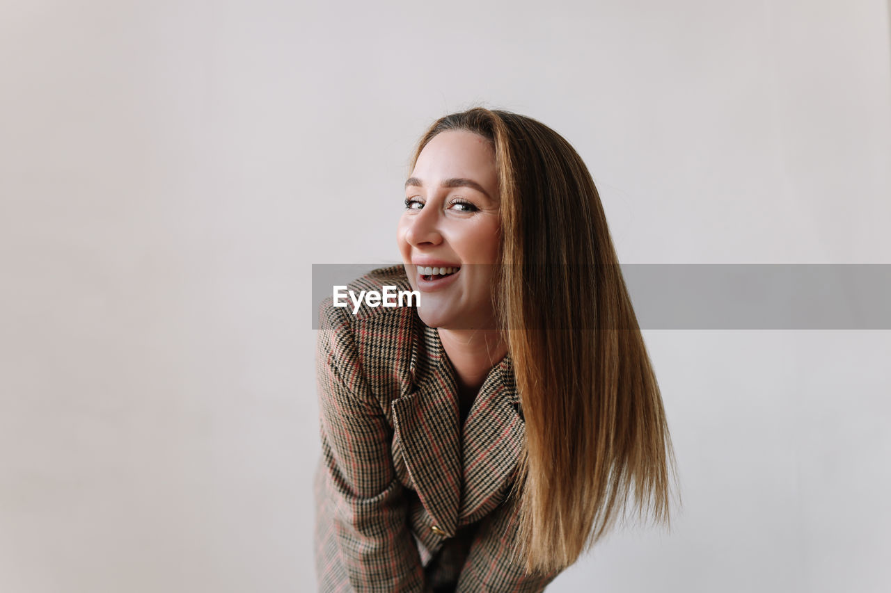 Portrait of a happy positive emotional woman looking into the camera on a white isolated background