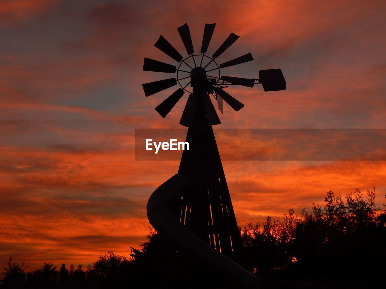 LOW ANGLE VIEW OF SILHOUETTE WINDMILL AGAINST ORANGE SKY