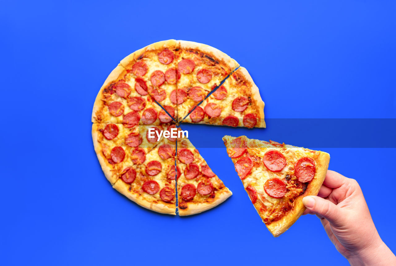 close-up of pizza on blue background