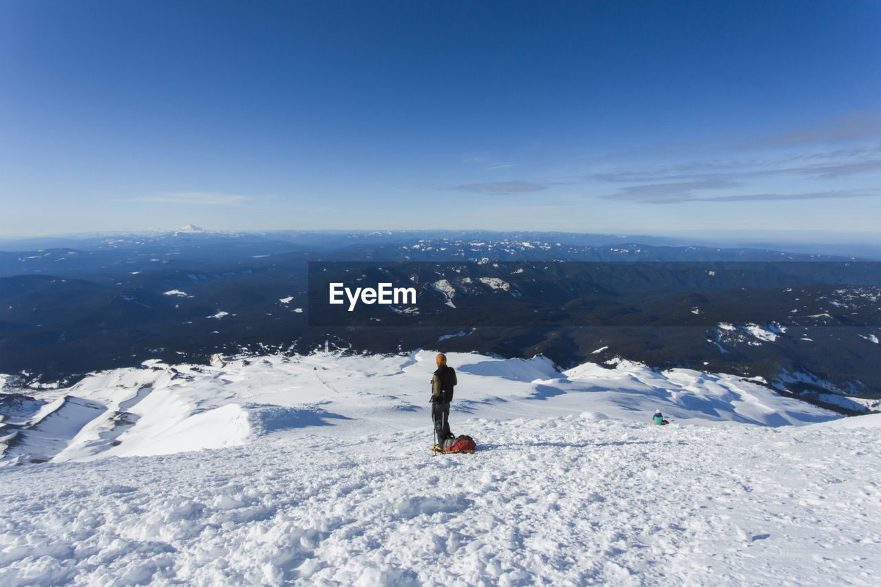 A man climbs to the summit of mt. hood in oregon.