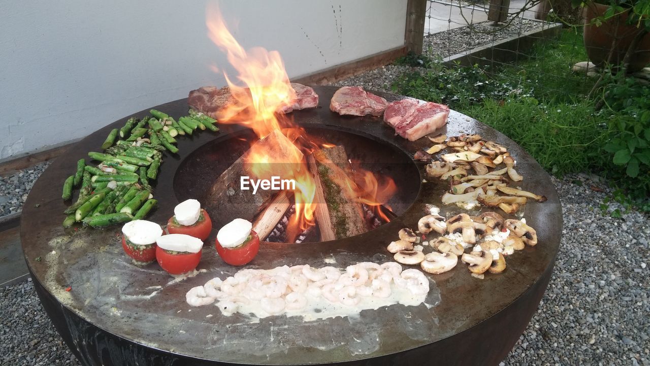 HIGH ANGLE VIEW OF BONFIRE ON BARBECUE