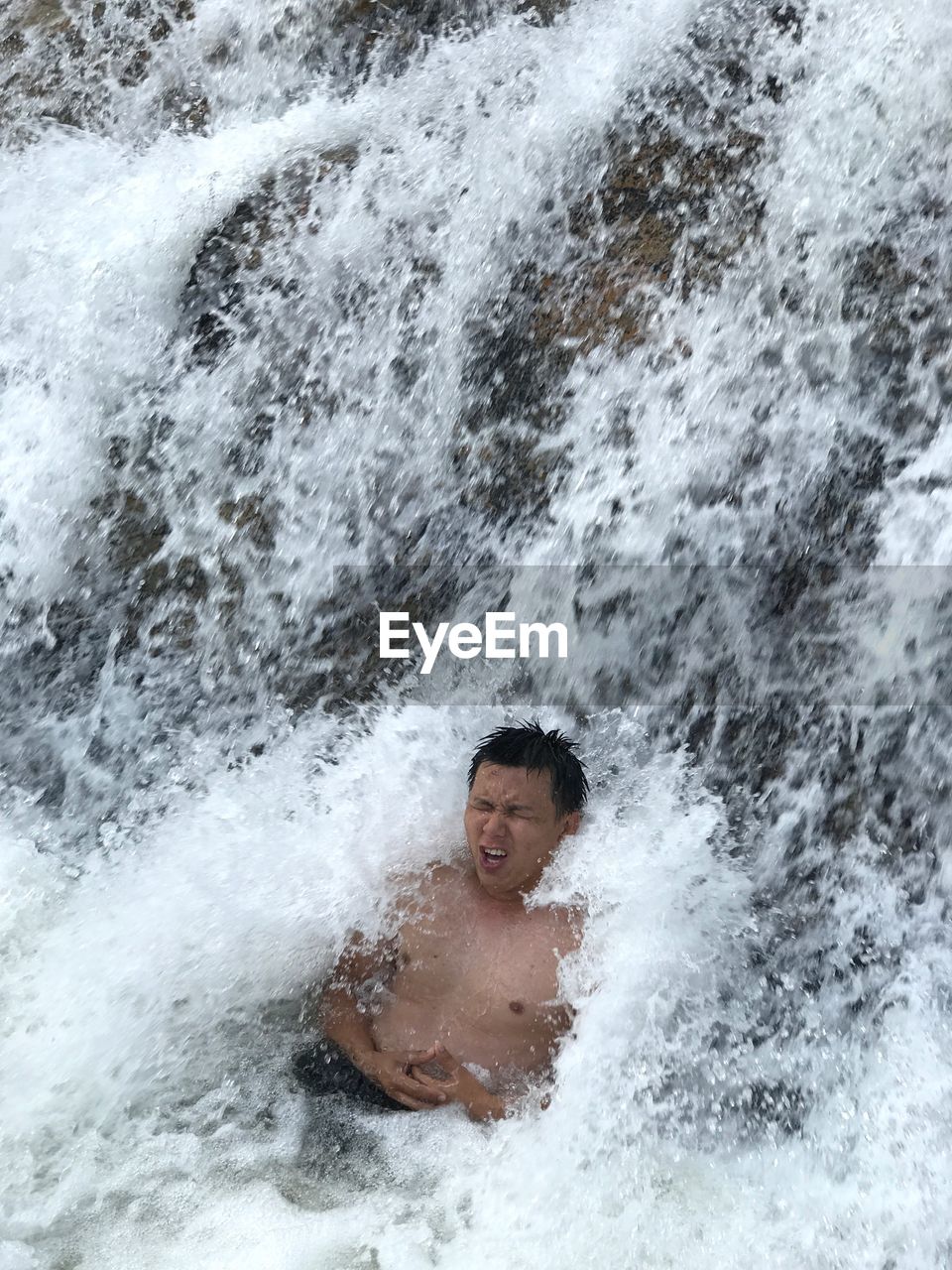High angle view of man in waterfall