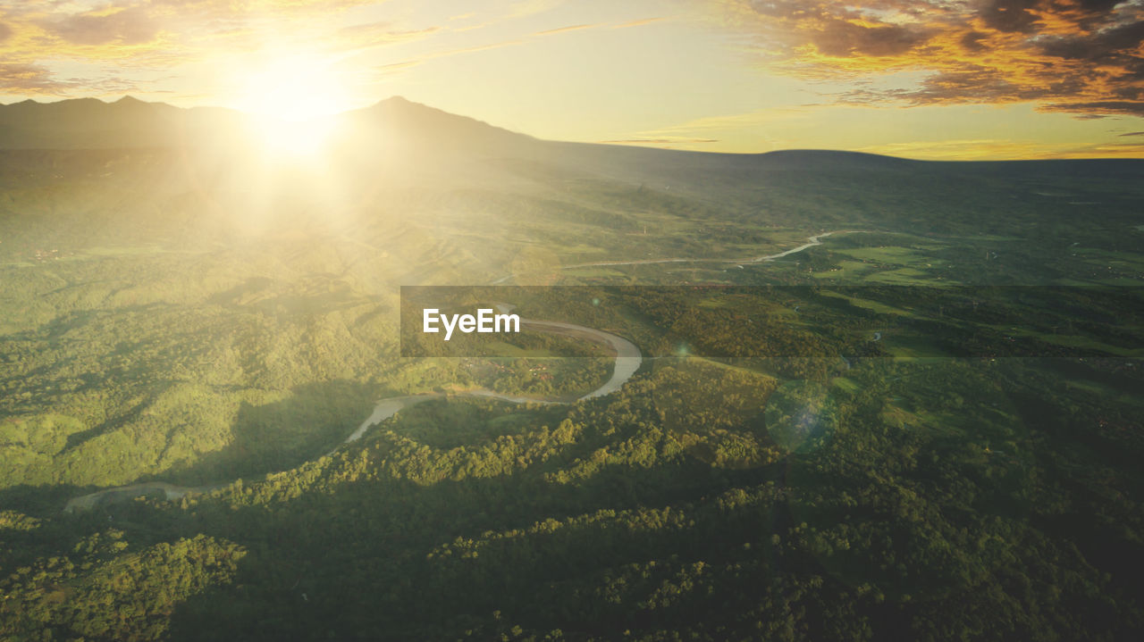 SCENIC VIEW OF LANDSCAPE AGAINST SUNSET SKY