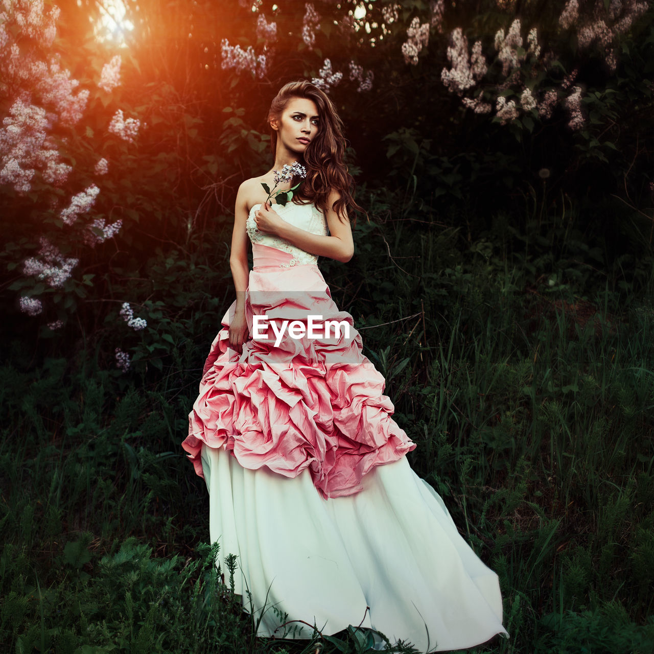 Beautiful mid adult woman standing on grassy field