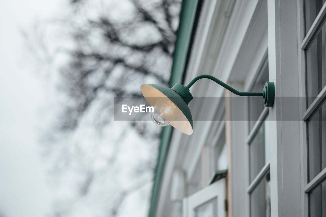 Low angle view of street light against building