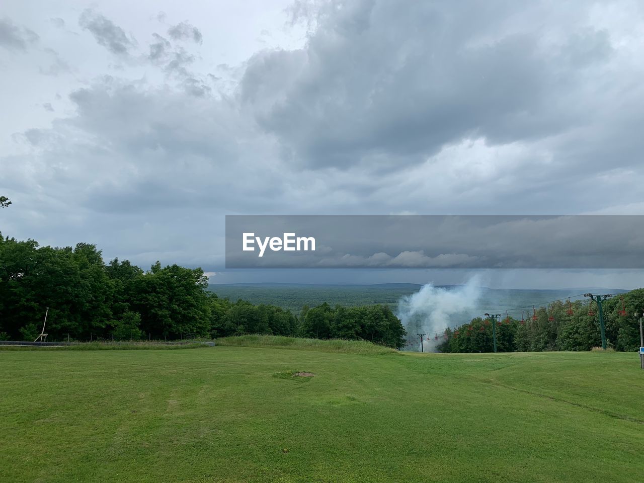 SCENIC VIEW OF WATERFALL AGAINST SKY