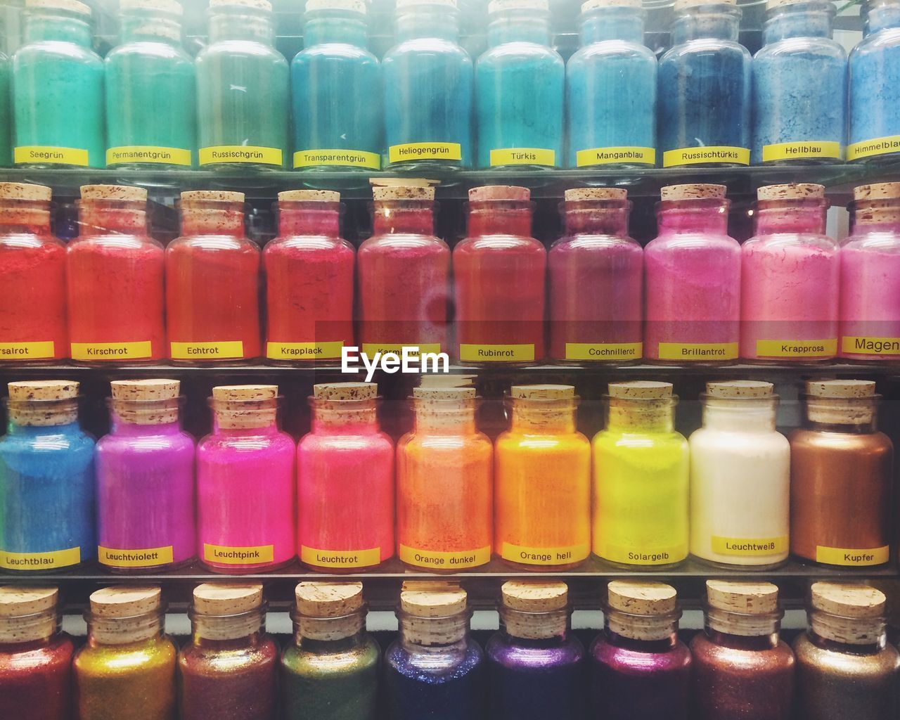 Full frame shot of colorful powder paint bottles on display in store