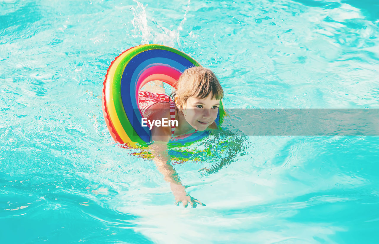 Smiling girl swimming in pool