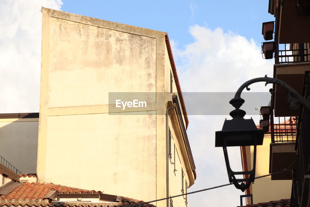 architecture, sky, built structure, building exterior, cloud, nature, sunlight, low angle view, day, city, no people, urban area, facade, industry, outdoors, wall, building