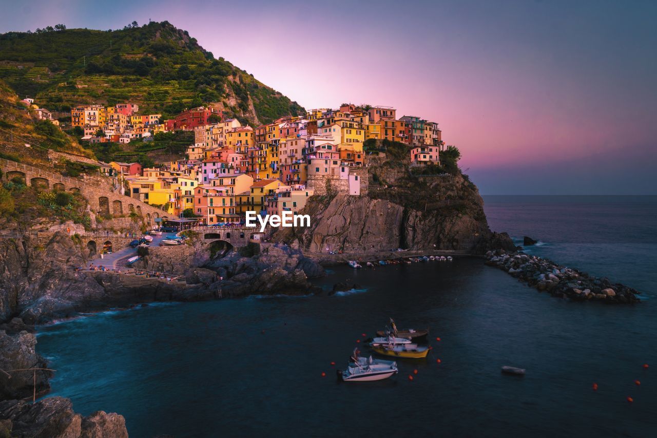 Scenic view of sea and buildings against sky