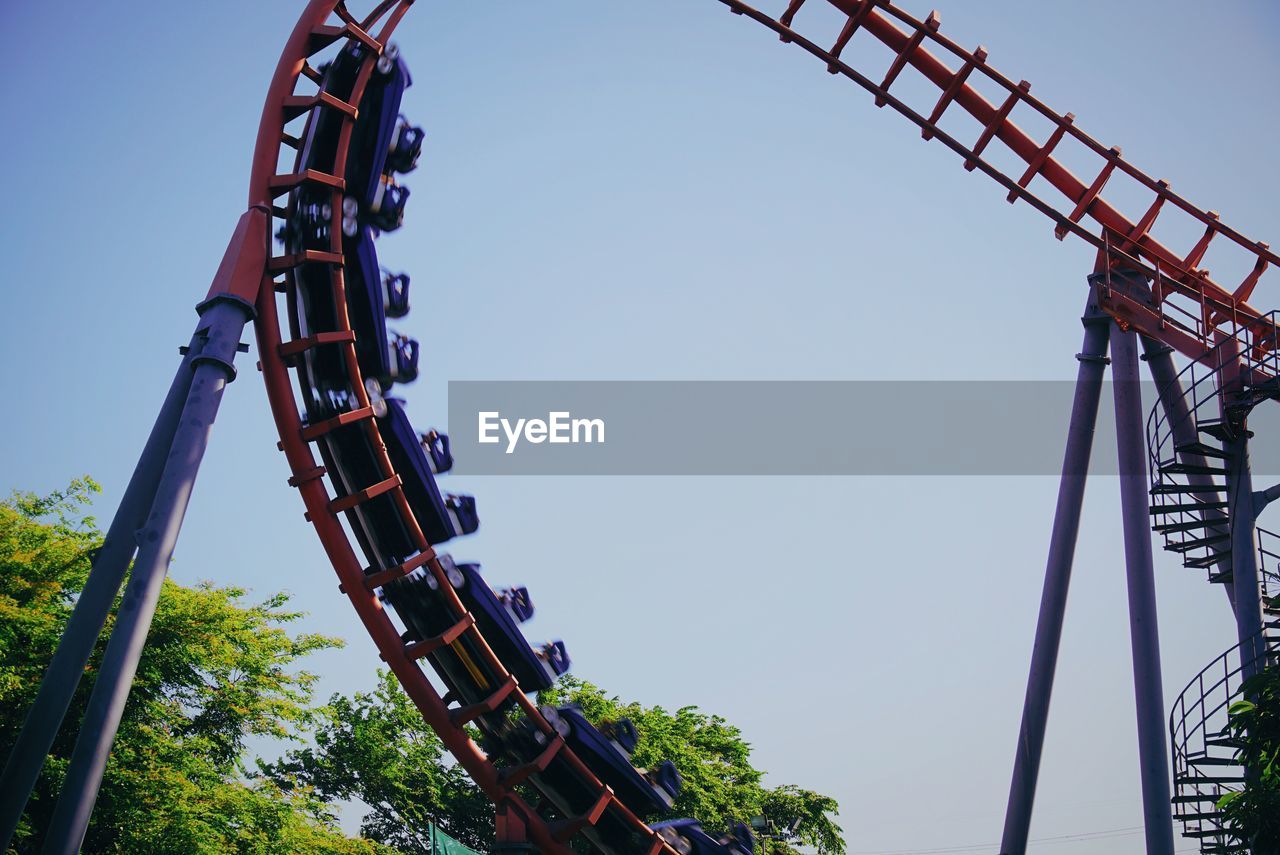 Low angle view of rollercoaster in action