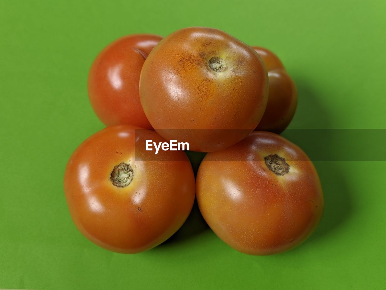 food, food and drink, healthy eating, plant, fruit, tomato, produce, wellbeing, freshness, colored background, vegetable, studio shot, indoors, green background, no people, group of objects, close-up, green, plum tomato, still life, raw food, ripe, red, organic