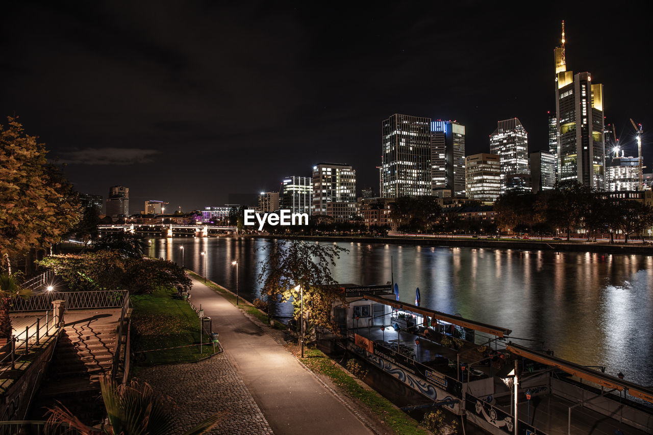 high angle view of illuminated bridge over river in city at night