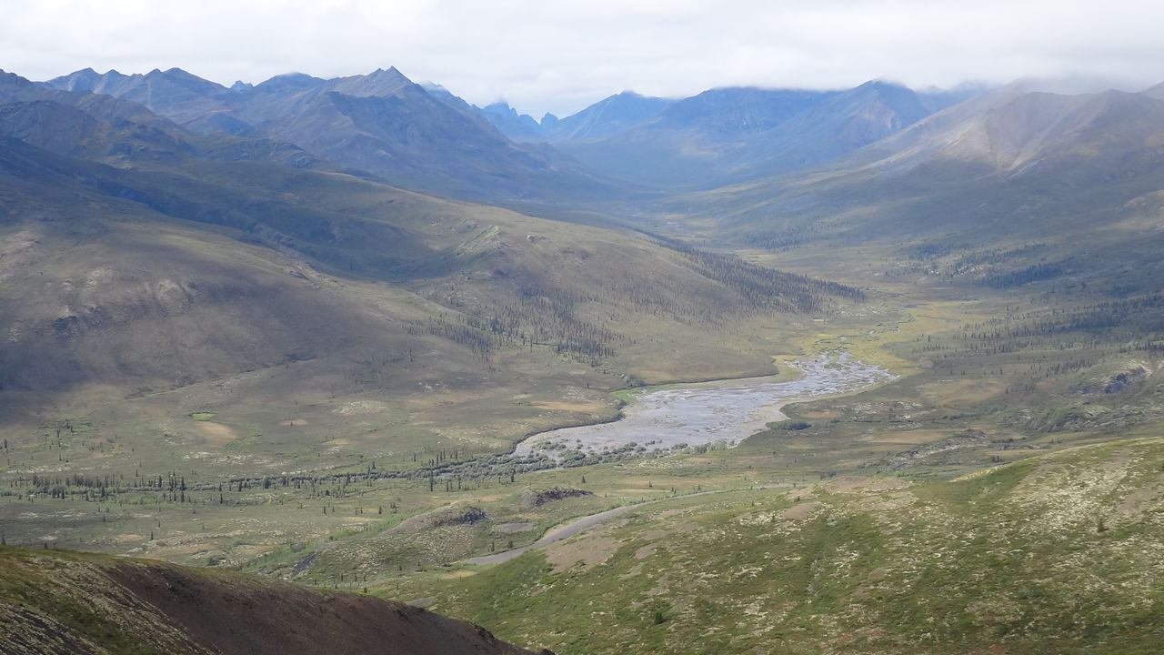 SCENIC VIEW OF ROAD BY MOUNTAINS AGAINST SKY