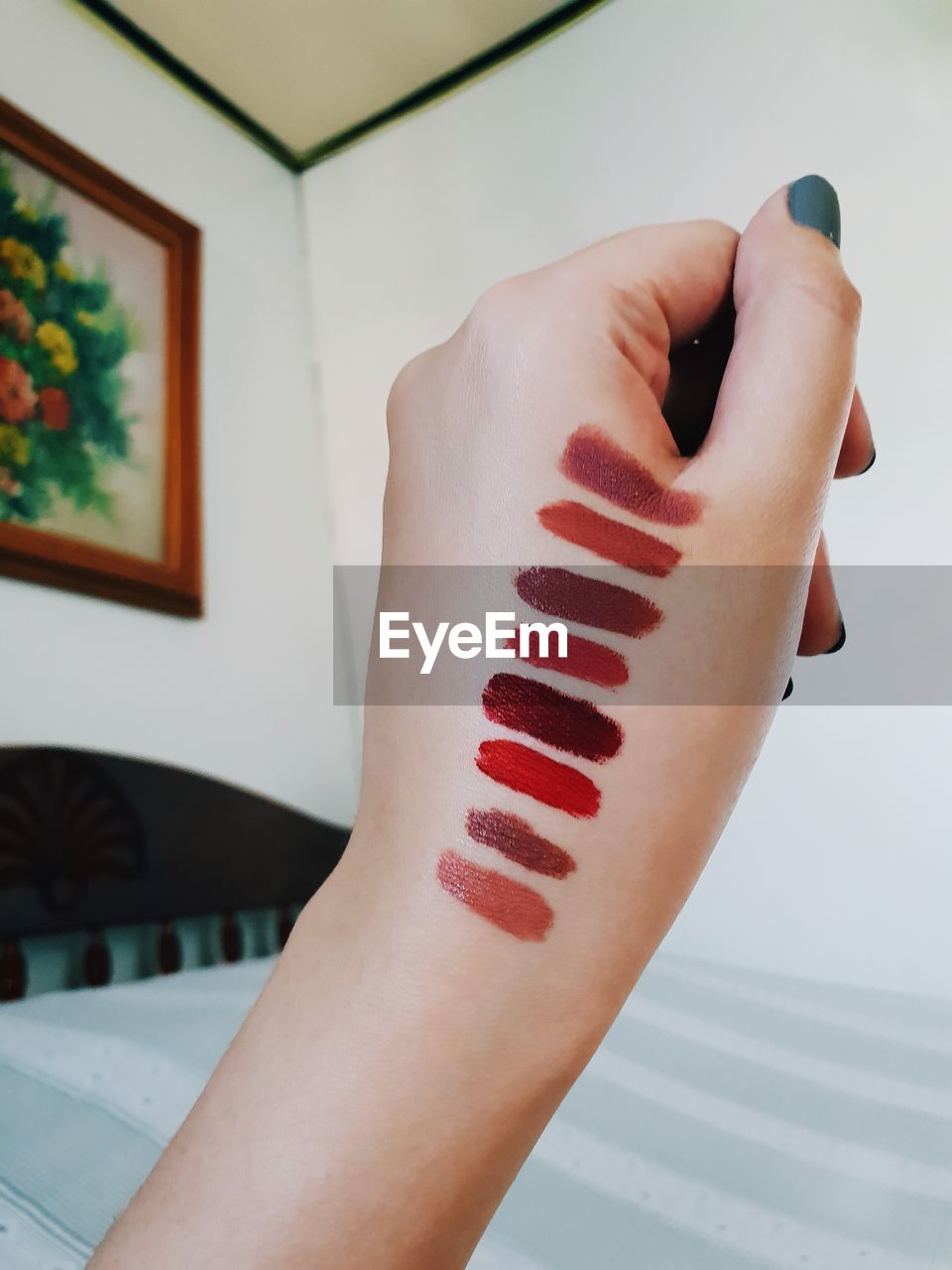 Close-up of lipstick shades on hand at home