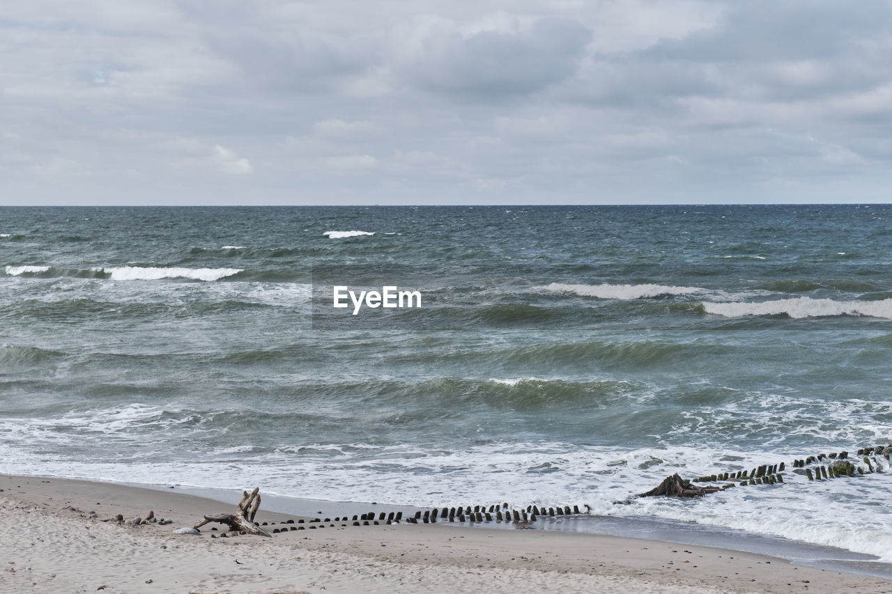 SCENIC VIEW OF SEA SHORE AGAINST SKY