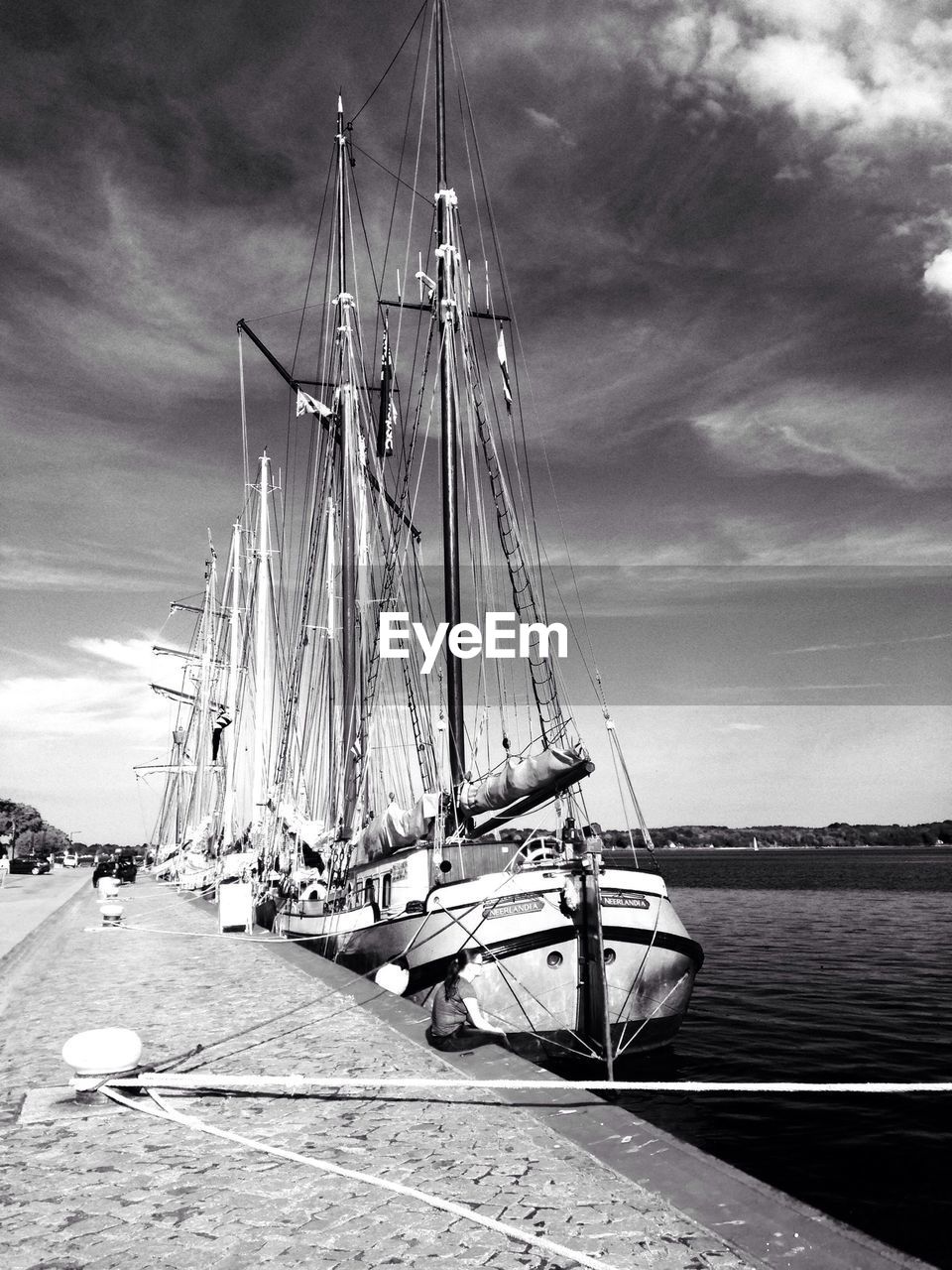 Boats moored at pier against the sky