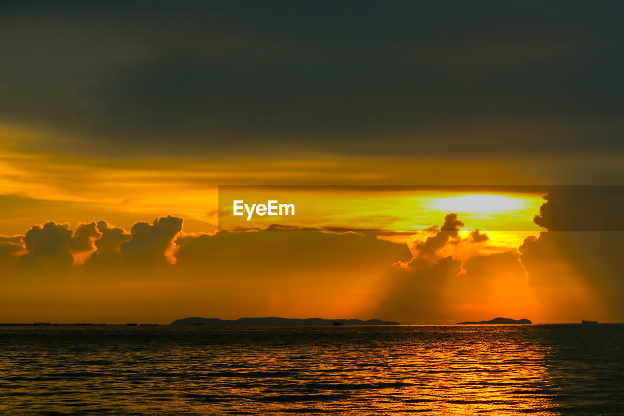 SCENIC VIEW OF SEA AGAINST ORANGE SKY DURING SUNSET