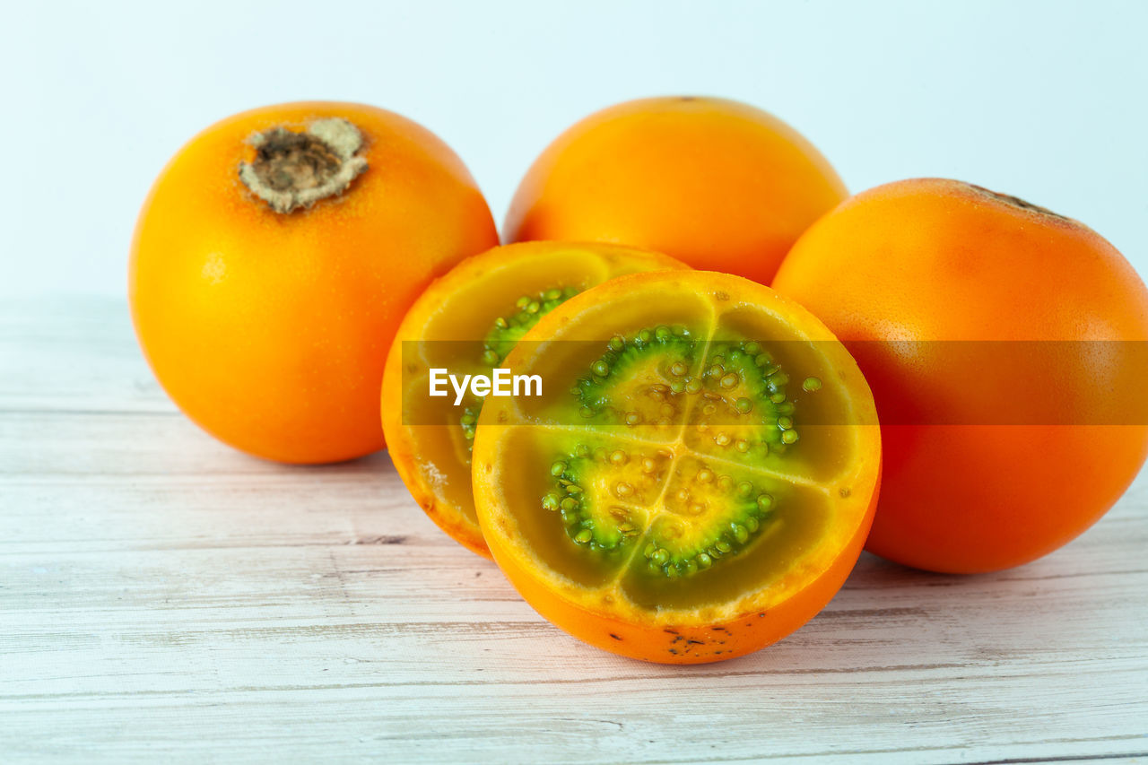 food and drink, food, healthy eating, wellbeing, freshness, fruit, orange color, plant, studio shot, produce, cross section, indoors, wood, vegetable, no people, yellow, slice, still life, halved, group of objects, citrus fruit, tomato, close-up, vitamin, pumpkin