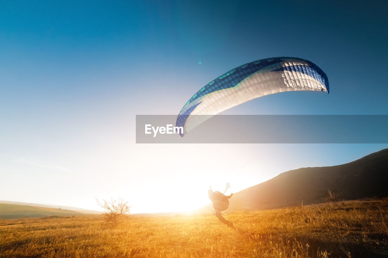 Launching a speedwing from a mountain. a paraglider is preparing to take off from a mountain