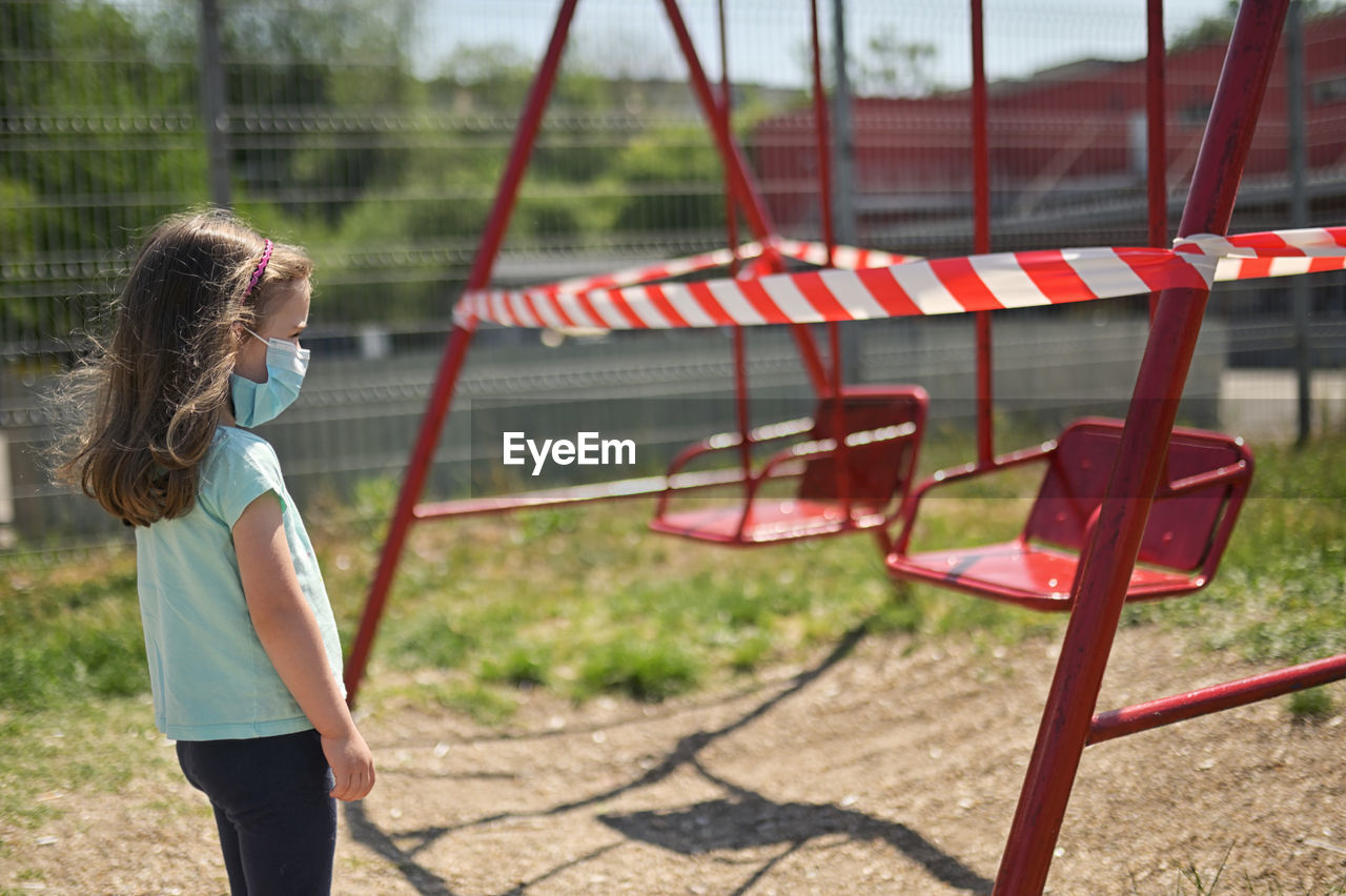 Side view of girl standing outdoors