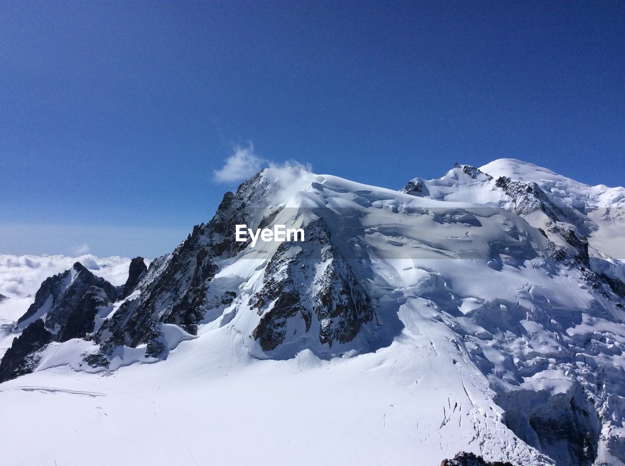 Scenic view of mountains against cloudy sky