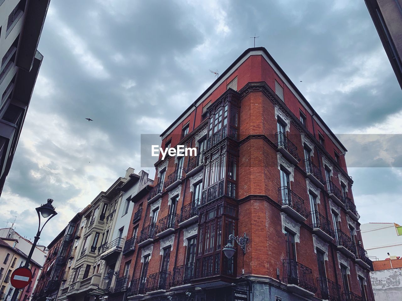 Low angle view of building against cloudy sky